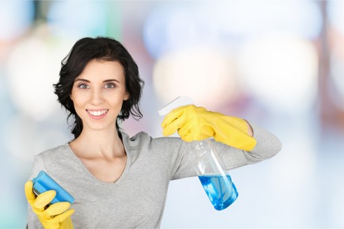 Office cleaning team disinfecting desks and shared surfaces in E3