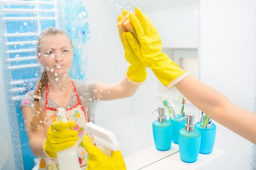 Technician using eco-friendly oven cleaner in E3 on oven racks